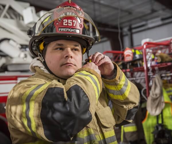 fireman putting on helmet