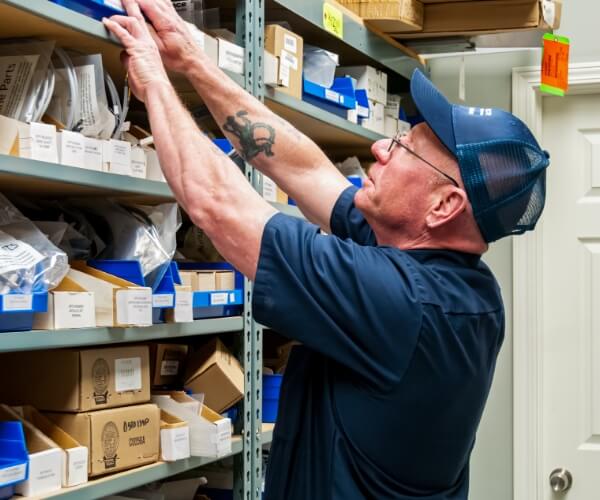 man taking parts off shelf